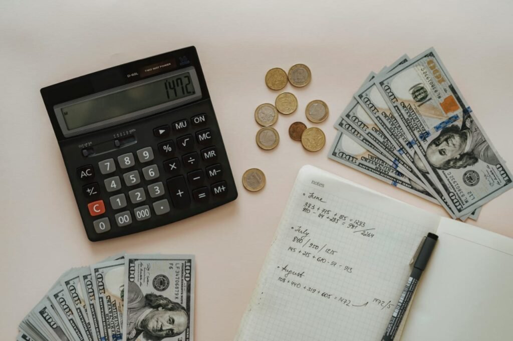 Image of some dollars and calculator placing on table