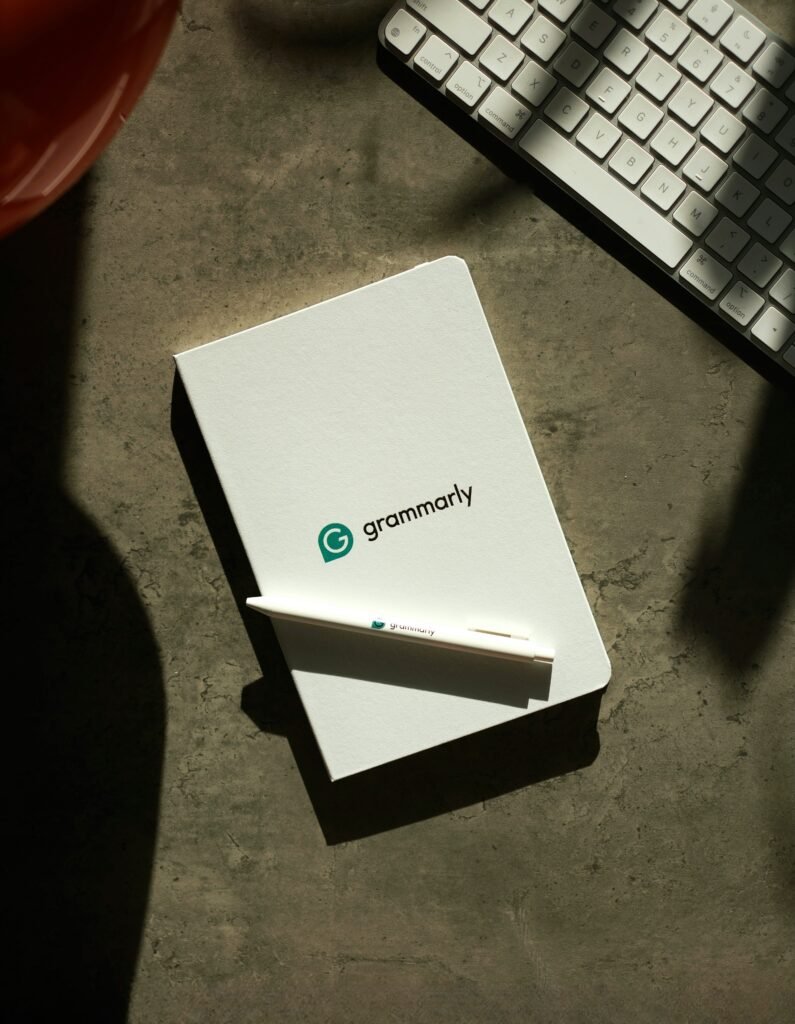 Grammarly logo on notepad with a pen 
